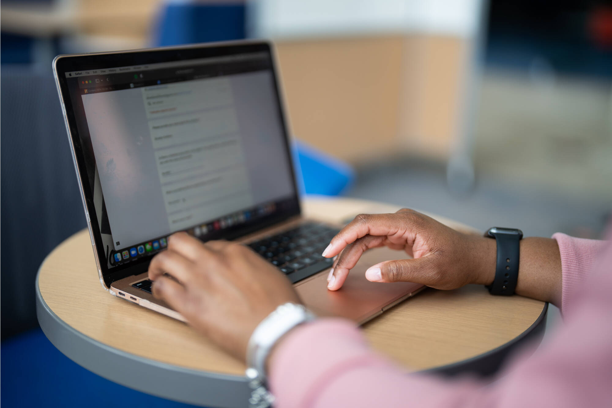 A student typing on a laptop